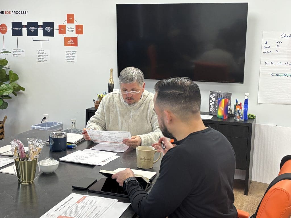 Tom Malesic speaking with a client about quarterly planning and rocks.